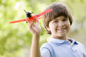 young boy with toy plane
