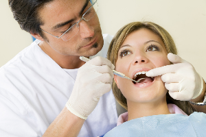 dentist performing checkup on patient