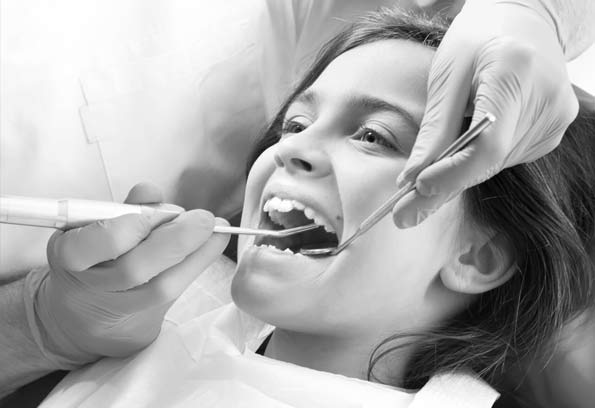 stock image of young patient undergoing teeth cleaning