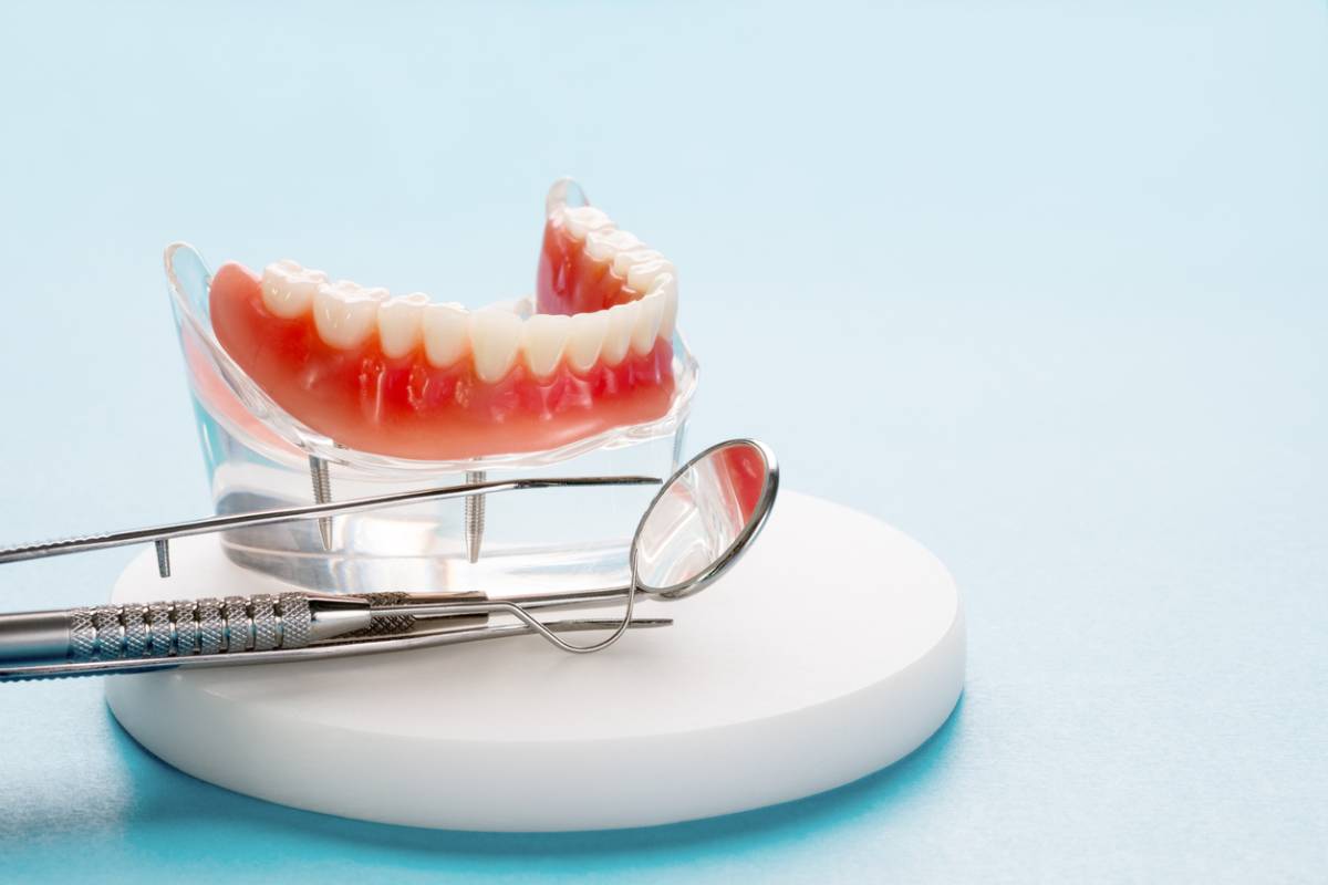 conventional dentures sitting on round white disc.