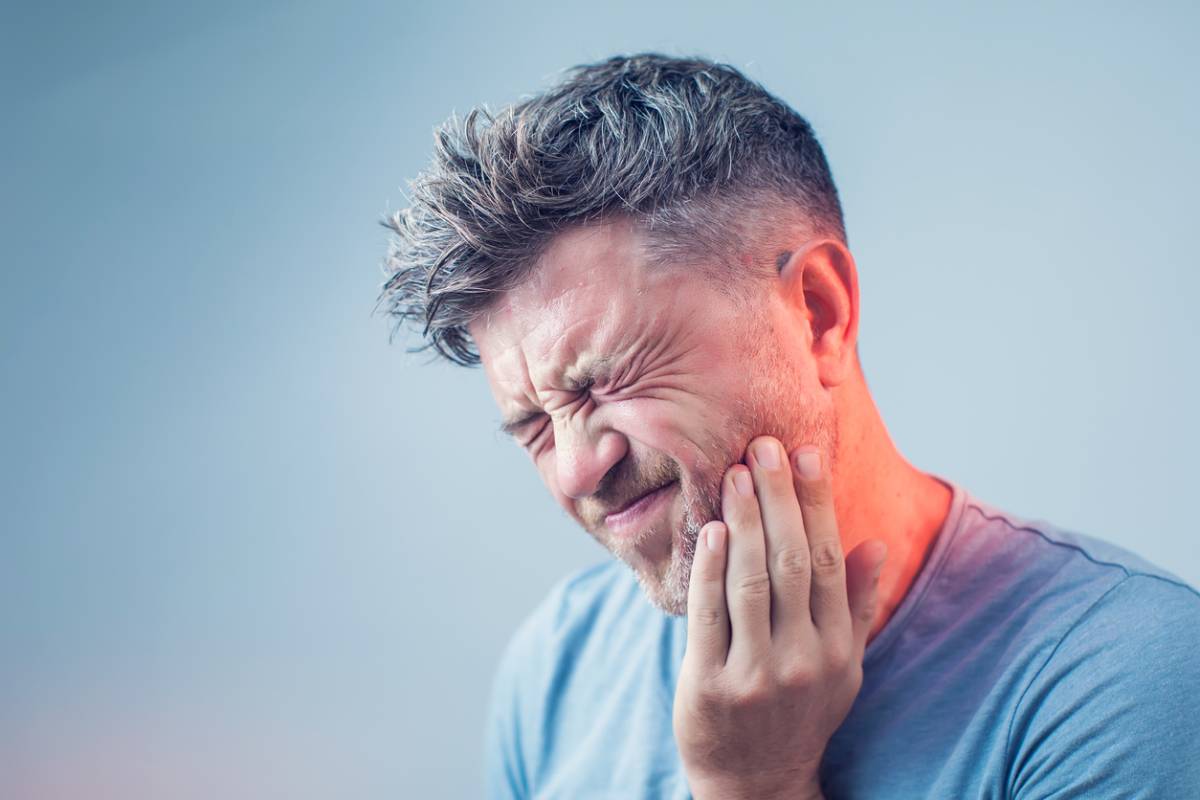 Man having sudden tooth pain