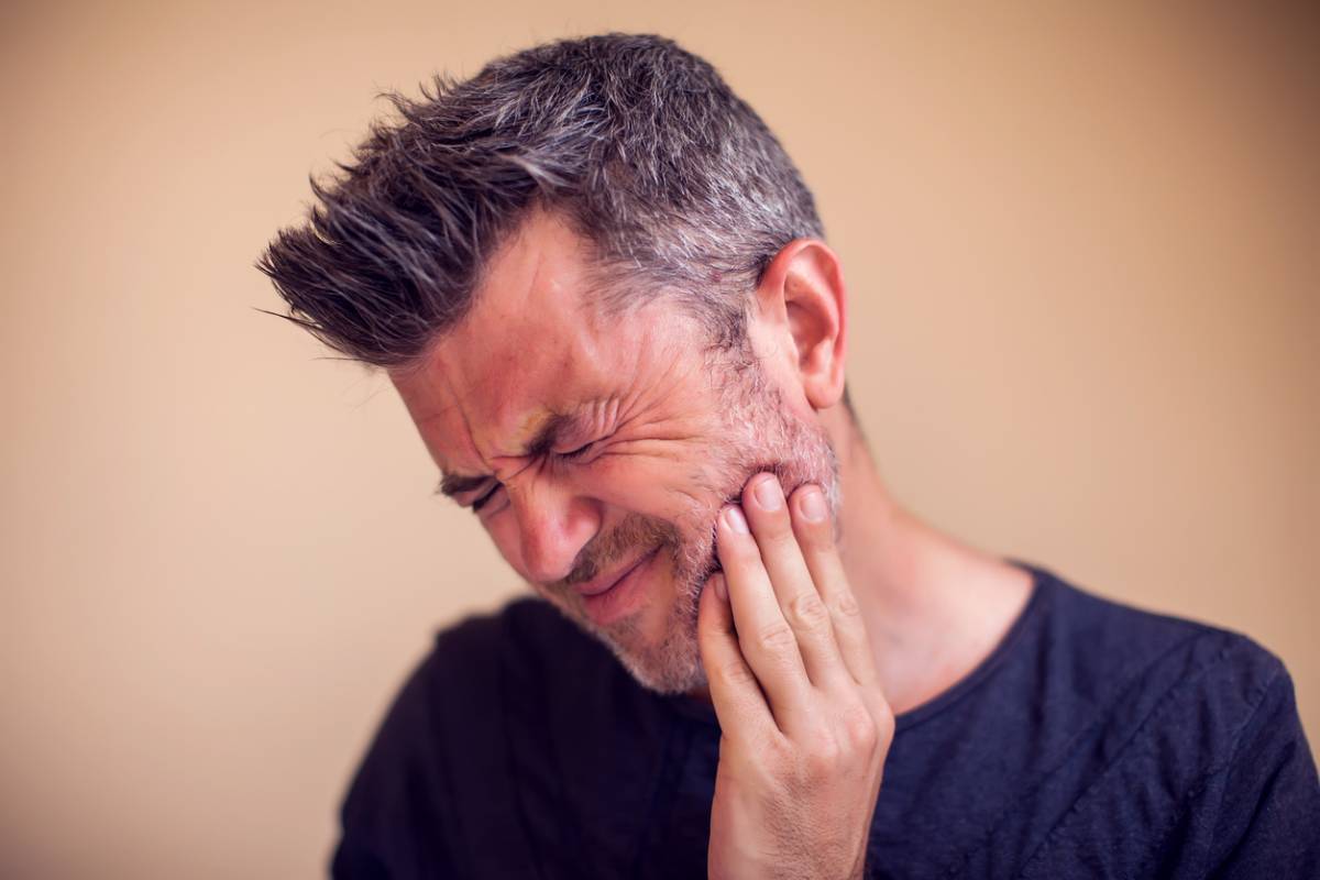 Man feels toothache.